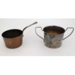 A miniature copper brandy warming pan of saucepan form together with a silver two handled cup? (