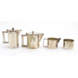 An Art Deco 4-pieces EPNS tea set comprising teapot hot water pot, milk jug and sugar bowl.