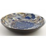 A Royal Copenhagen Faience dish of circular form decorated in shades of blue and grey on a white