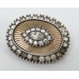 A vintage silver brooch with gilt and paste stone decoration.