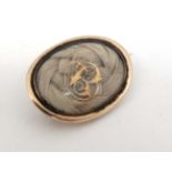 Mourning / Memorial Jewellery : A 19thC gilt metal mourning brooch with central glazed section