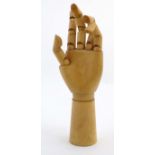 An artists wooden mannequin / lay figure hand with jointed digits.