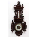 Barometer: a carved wood surround with dolphins aneroid barometer and enamel backed alcohol