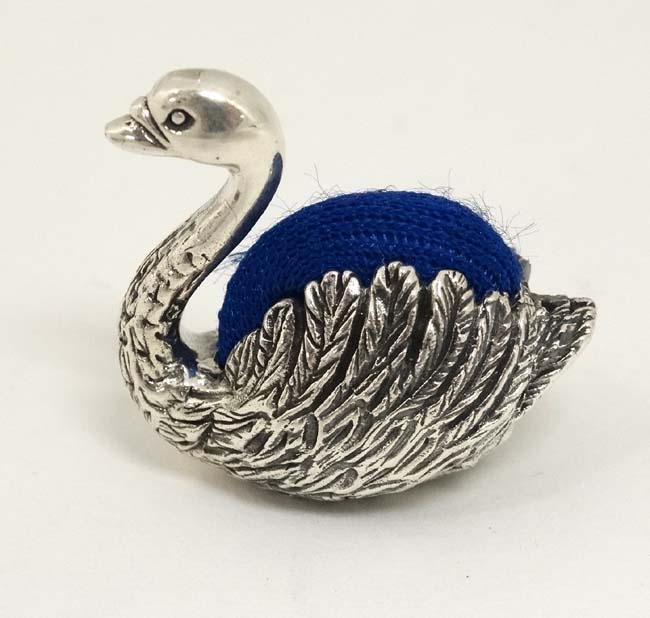 A novelty white metal pin cushion formed as a swan 1" high CONDITION: Please Note -