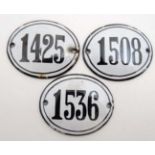 Three French vintage French enamel number of oval form, probably vintners bin numbers.