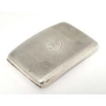 An Art Deco silver cigarette case of shaped form with engine turned decoration.