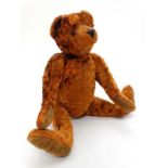 An Auburn coloured plush coated Teddy Bear, fully jointed with rexine style pads,