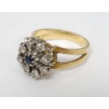 An 18ct gold ring with central sapphire bordered by 8 diamonds CONDITION: Please