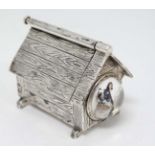 An unusual novelty vesta case formed as a dog kennel with sprung opening roof and striker under and