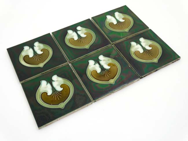 A set of six early 20thC Art Nouveau tube lined green Majolica lustre tiles decorated to centre