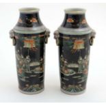 A pair of Chinese Famille Noir vases. Black vases with oriental figure and landscape decoration.