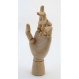 An artists wooden mannequin / lay figure hand with jointed digits.