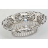 A silver bon bon dish of basket form with pierced and embossed decoration.