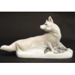 A figurine modelled as a fox with duck at its feet,