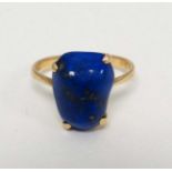 A gold ring set with lapis lazuli stone.