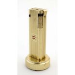 Lighter : A Cygnus Japan gilt aluminium petrol table lighter marked to side.