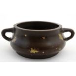 A Chinese patinated bronze gold splash 2-handled shot pot / censor with 4 character stamp under.