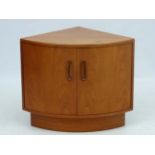 Vintage Retro : a British Teak G Plan Fresco corner unit of bowed design with 2 doors .