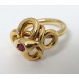 A gold ring formed as a coiled snake with inset ruby to head.