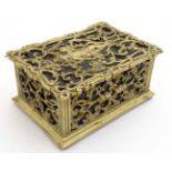 A late 19tmhC brass and cedar lined humidor with image to top of putti amongst Rococo brass ware 8"