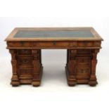 An oak pedestal desk with tooled green leather insert 53 1/2" wide x 30 3/4" deep x 31 1/2" high