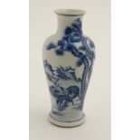 A Chinese blue and white vase decorated with deer in a rocky landscape under pine trees,