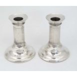 A pair of Victorian silver candlesticks of short column form hallmarked London 1887 maker Horace