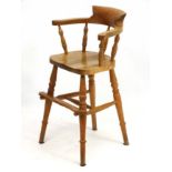 A 20thC Blonde oak childs high chair formed as a small smokers bow 31" high CONDITION: