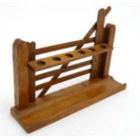An early 20thC novelty pipe rack of 6 divisions formed as a gate 12" wide x 3" deep x 8" high