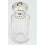 A cut glass scent bottle with silver top hallmarked London 1900 3 1/2" high