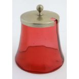A cranberry glass preserve pot with silver plated lid.