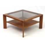 Vintage Retro : A Teak and glass top coffee table with under tier shelf standing on four legs,