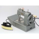 Toys: A Miniature / child's sewing machine together with a small iron (2) CONDITION: