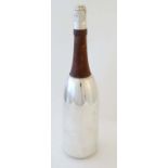 A 21stC silver plate novelty cocktail shaker formed as a Champagne bottle,