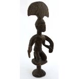 Ethnographica : A Native Tribal : An African carved wooden Yoruba crested figure knelt on a