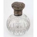 A cut glass scent bottle of spherical form with silver top hallmarked London 18974 maker Mappin