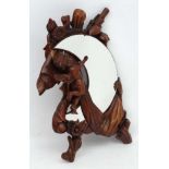 A Victorian style carved wooden wall mirror with cherub decoration and crescent moon shaped mirror