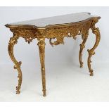 Mid Century / Hollywood Regency : a Rococo Revival gilt serpentine shaped console table with stone
