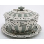 A c1925 Wedgwood green and white motto ware plate and pot and cover by Harry Barnard,