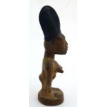 Ethnographica : A Native Tribal : an African carved wooden Ibeji figure with traces of original