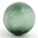 An old green glass spherical fishing float,