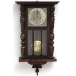 Clock : an early 20 thC Walnut cased 8 day Wall clock with sprung movement striking on a gong,