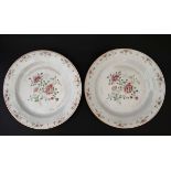 A pair of Chinese famille rose plates decorated with peony's on a white ground. 9'' diameter.