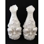 A pair of Chinese lotus leaf Blanc de Chine style vases having applied goldfish decoration to bases.