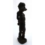 Ethnographica : A Native Tribal : a carved ebony figure of an African slave stood wearing leg