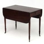 A Geo IV mahogany Pembroke table with one true and one sham drawer.
