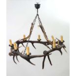 Light :an impressive Red deer antler pendant chandelier having four hanging sections ( 2 of which