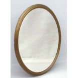 Large oval Regency wall mirror with gilded and moulded surround ,