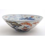 A Japanese Edo style bowl decorated in Imari colours with birds among flowering boughs on rocky