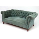A c.1900 button back Chesterfield sofa with walnut legs.